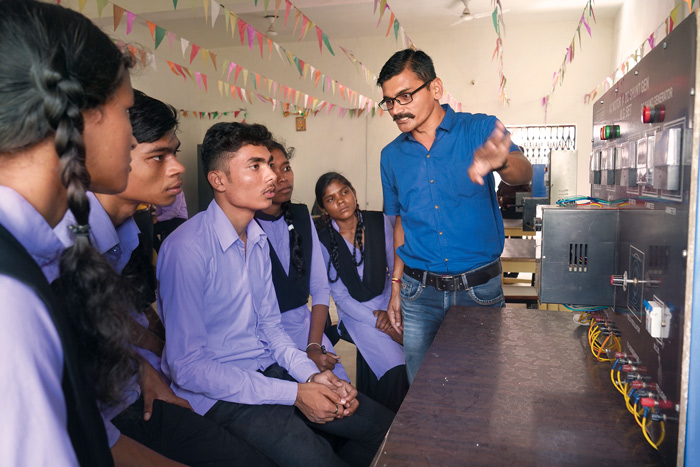 Lab technicianAjay Jain with students at the NMDC Polytechnic, Geedam