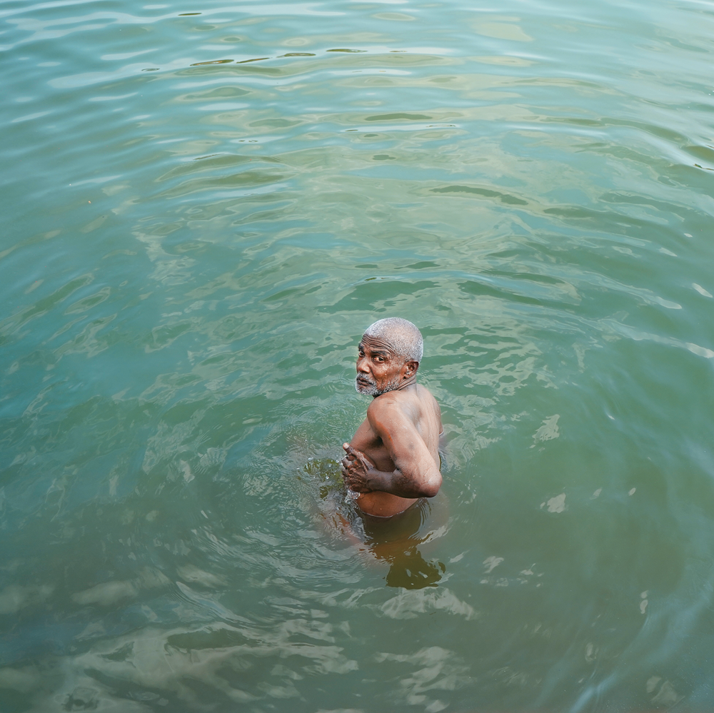 A devotee taking a
dip in the Shiv Ganga Lake, Deogarh